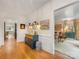 Bright hallway leading to living room and featuring hardwood floors and stylish decor at 2912 Wheelock Rd, Charlotte, NC 28211