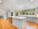 Bright kitchen features a large island with seating and marble countertops, stainless steel appliances, and hardwood floors at 2912 Wheelock Rd, Charlotte, NC 28211