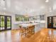 Spacious kitchen with a large island with seating, hardwood floors, and a window overlooking the backyard at 2912 Wheelock Rd, Charlotte, NC 28211