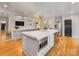 Bright kitchen with stainless steel appliances, a large island with seating, and hardwood floors at 2912 Wheelock Rd, Charlotte, NC 28211