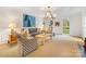 Inviting living room featuring designer furniture and ample natural light from many windows at 2912 Wheelock Rd, Charlotte, NC 28211