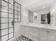 Modern main bathroom featuring a glass enclosed shower, double sinks, and stylish black and white tile at 2912 Wheelock Rd, Charlotte, NC 28211