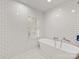 Modern main bathroom featuring a standalone tub, white tile and herringbone floors at 2912 Wheelock Rd, Charlotte, NC 28211