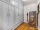 Built in storage cabinets with an additional wine refrigerator on hardwood floors at 2912 Wheelock Rd, Charlotte, NC 28211