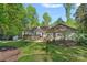 Expansive backyard featuring a well-maintained lawn and lush landscaping with a large deck at 2915 Cross Country Rd, Charlotte, NC 28270