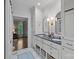 Bright bathroom featuring a double vanity with marble floors, and gold fixtures at 2915 Cross Country Rd, Charlotte, NC 28270
