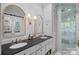 Elegant bathroom features dual sinks with brass fixtures, marble countertop, and a glass shower enclosure at 2915 Cross Country Rd, Charlotte, NC 28270