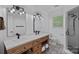 A modern bathroom with double vanity, new fixtures, and updated tile in the shower and on the floor at 2915 Cross Country Rd, Charlotte, NC 28270