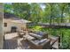 A comfortable outdoor living area with wicker furniture and a grill overlooking a green lawn at 2915 Cross Country Rd, Charlotte, NC 28270