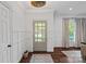 This home's entryway has great natural light, wainscoting, and beautiful wood flooring at 2915 Cross Country Rd, Charlotte, NC 28270