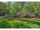 Exterior view of home's manicured lawn, mature trees and well-maintained landscape at 2915 Cross Country Rd, Charlotte, NC 28270