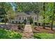 Charming single-story home with a landscaped front yard, inviting walkway, and classic white brick exterior at 2915 Cross Country Rd, Charlotte, NC 28270