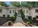 Traditional home with a painted brick exterior and professionally landscaped front yard and entry at 2915 Cross Country Rd, Charlotte, NC 28270
