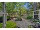 Landscaped garden area with plants, gravel pathways, and a wooden fence at 2915 Cross Country Rd, Charlotte, NC 28270