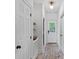 A hallway offers brick flooring, built-in shelving, and access to the outside at 2915 Cross Country Rd, Charlotte, NC 28270