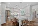 Bright kitchen boasts white cabinets, marble island with bar seating, and stainless steel appliances at 2915 Cross Country Rd, Charlotte, NC 28270
