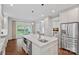This kitchen has a large island with seating, stainless appliances, and access to the backyard at 2915 Cross Country Rd, Charlotte, NC 28270
