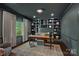 Sophisticated home office with built-in shelving, hardwood floors, and a large window at 2915 Cross Country Rd, Charlotte, NC 28270