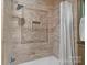 Shower with decorative tile, a built-in niche, and a modern showerhead at 2915 Cross Country Rd, Charlotte, NC 28270