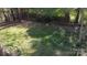 A sprawling green backyard features a rock outline in a circular design at 314 Bass Ln, Charlotte, NC 28270