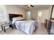 Bedroom with two windows and ensuite bath, showing a striped bed and a ceiling fan at 314 Bass Ln, Charlotte, NC 28270