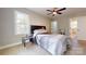 Bedroom with open ensuite, featuring modern bed and hardwood floors at 314 Bass Ln, Charlotte, NC 28270