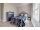Bedroom featuring a black and white patterned bed, chest of drawers, and wood-look floors at 314 Bass Ln, Charlotte, NC 28270