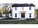 Beautiful two-story home with a white brick exterior, black roof, and manicured landscaping at 314 Bass Ln, Charlotte, NC 28270