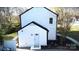 View of the exterior back of the white home with a small building adjacent to the primary home at 314 Bass Ln, Charlotte, NC 28270
