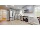 Modern kitchen with stainless steel appliances, gray cabinets, and white subway tile backsplash at 314 Bass Ln, Charlotte, NC 28270