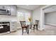 Eat-in kitchen featuring modern decor, a glass table, and adjacent stainless steel appliances at 314 Bass Ln, Charlotte, NC 28270