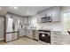 Well-appointed kitchen featuring modern appliances, gray cabinets, and ample counter space at 314 Bass Ln, Charlotte, NC 28270