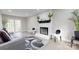 Inviting living room with a painted brick fireplace and French doors to the exterior at 314 Bass Ln, Charlotte, NC 28270