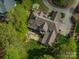 Aerial view of a luxurious home with an outdoor firepit and pristine landscaping at 3160 Ashwood Park Dr, Belmont, NC 28012