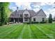 Expansive backyard with lush lawn, patio seating, and mature trees, offering an ideal space for outdoor entertaining at 3160 Ashwood Park Dr, Belmont, NC 28012