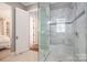 Modern bathroom with glass shower, marble tile, and convenient seating at 3160 Ashwood Park Dr, Belmont, NC 28012