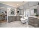 Luxurious bathroom showcasing dual vanities, a standalone tub, and marble flooring, offering a spa-like experience at 3160 Ashwood Park Dr, Belmont, NC 28012