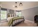 Bedroom featuring a metal frame bed, neutral decor, and window views that combine comfort and style at 3160 Ashwood Park Dr, Belmont, NC 28012