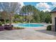 Resort-style community pool surrounded by mature trees, a sundeck, and lush landscaping at 3160 Ashwood Park Dr, Belmont, NC 28012