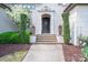 Home's front entrance features a beautiful wood door and detailed stone trim at 3160 Ashwood Park Dr, Belmont, NC 28012