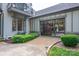 Stunning exterior showcasing a unique garage door, adjacent to a balcony and lush landscaping at 3160 Ashwood Park Dr, Belmont, NC 28012