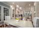 Bright open eat-in kitchen with modern lighting, white cabinets and dining table at 3160 Ashwood Park Dr, Belmont, NC 28012