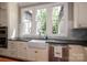 Eat-in kitchen featuring white cabinets, tile backsplash, apron sink, and stainless appliances at 3160 Ashwood Park Dr, Belmont, NC 28012