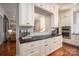 Eat-in kitchen featuring white cabinets, tile backsplash, hardwood floors, and stainless appliances at 3160 Ashwood Park Dr, Belmont, NC 28012