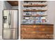Kitchenette with stainless steel fridge, custom wood cabinets, and open shelving at 3160 Ashwood Park Dr, Belmont, NC 28012