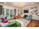 Spacious living room with modern lighting, a fireplace, and doors to backyard at 3160 Ashwood Park Dr, Belmont, NC 28012