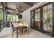 Screened-in porch with outdoor seating area, ceiling fans, and wood dining table at 3160 Ashwood Park Dr, Belmont, NC 28012