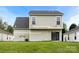 Spacious backyard featuring a sliding glass door entrance and well-maintained lawn and a detached garage at 3320 Alderknoll Ct, Charlotte, NC 28216
