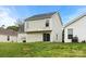 View of the back of the house with a sliding glass door overlooking a large grassy backyard at 3320 Alderknoll Ct, Charlotte, NC 28216