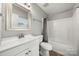 Well-lit bathroom features a single vanity, mirror, and shower-tub combo at 3320 Alderknoll Ct, Charlotte, NC 28216
